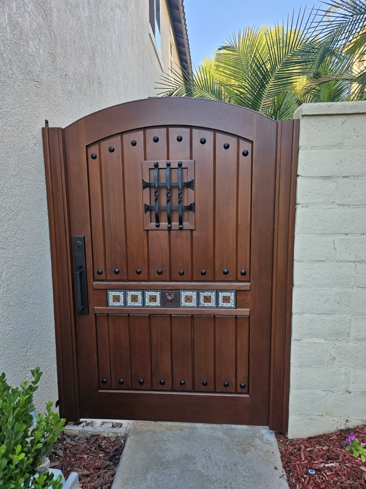 Custom wood and wrought-iron arched entry gate built by Weld4U