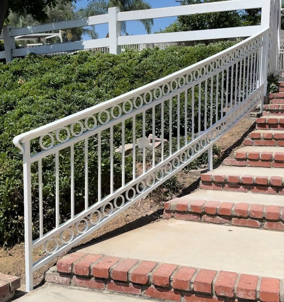 Decorative white metal stair railing fabricated and installed by Weld4U